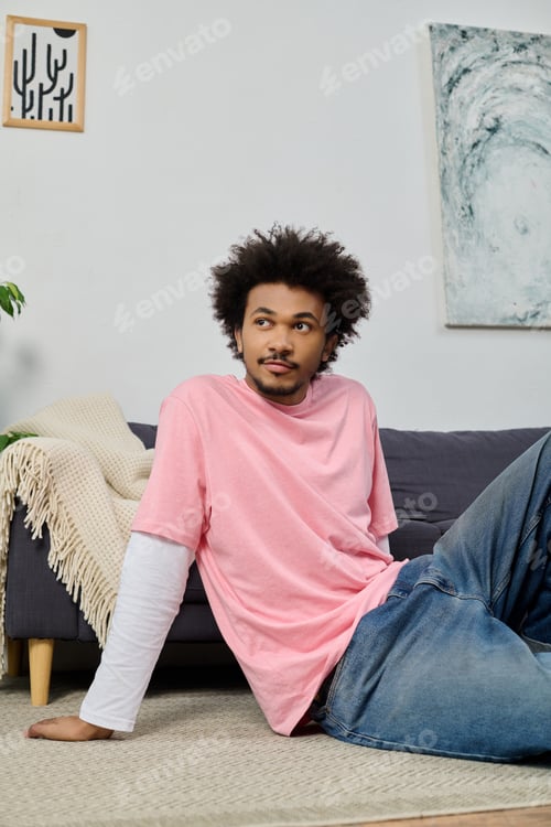 Preview: Young handsome man relaxing on sofa dressed in casual style with cozy home atmosphere