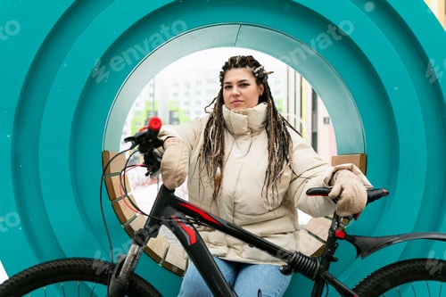 Preview: Woman With Dreadlocks Sitting on a Bike