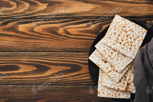 Preview: Passover celebration concept. Matzah, red kosher and walnut. Traditional ritual Jewish bread on sand