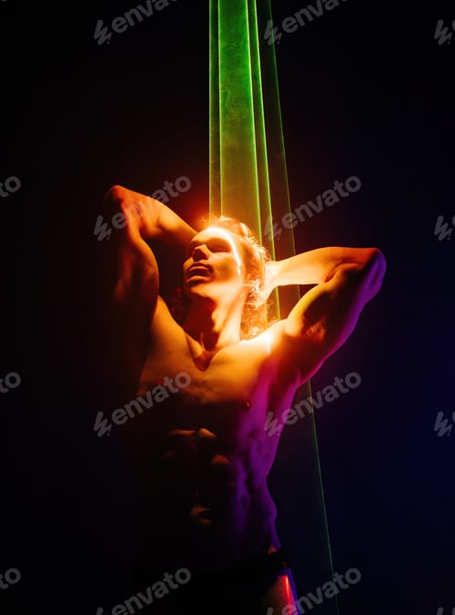 Preview: Sporty handsome muscular man portrait under colorful illumination, laser light