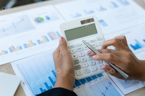 Preview: Business woman Calculating with a calculator to check investment results By checking the income bar