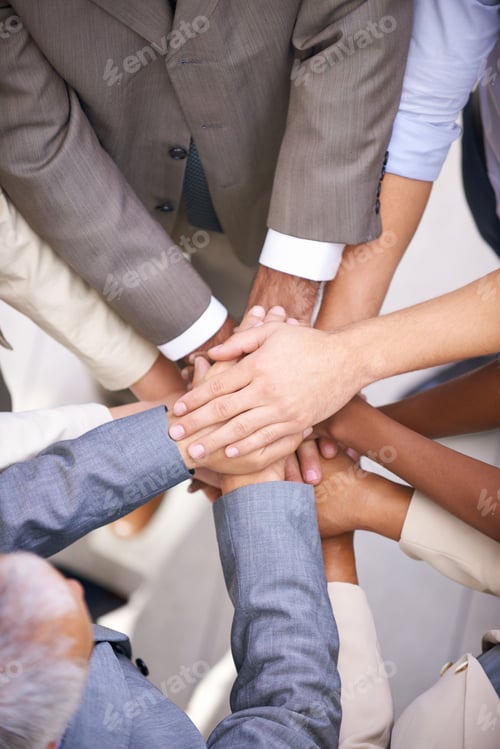 Preview: We can do this. Shot of a group of coworkers with their hands in a huddle.