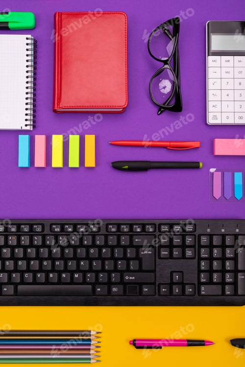 Preview: Modern working place with keyboard, diary, pencils, pens and glasses on orange-purple background