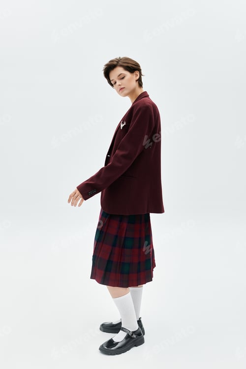 Preview: Elegant woman in cozy winter attire striking a pose against a minimal backdrop
