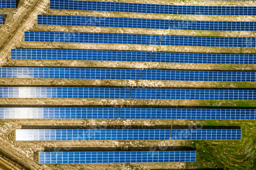 Preview: Top view of solar panels on green field