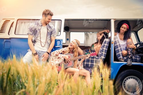 Preview: Happy friends driving a vintage minivan