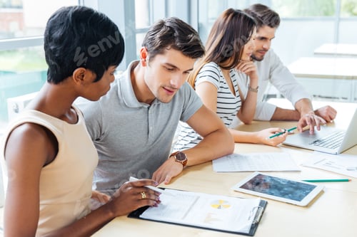 Preview: Multiethnic group of people creating business plan in office