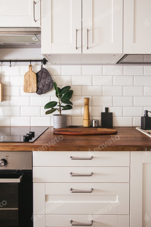 Vista previa: Hanging kitchen with white tiles wall and wood tabletop. Green plant on kitchen background