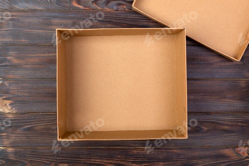 Preview: Opened brown blank cardboard box on wooden dark background, top view