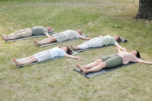 Preview: Group of yoga students lying in corpse pose