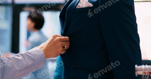Preview: Worker arranging elegant suit