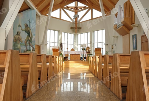 Preview: Modern empty catholic church interior brightly illuminated with natural window light