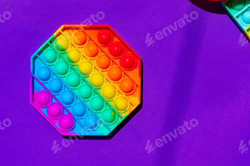Preview: Colorful antistress pop it toy on purple background