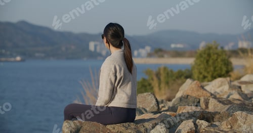 Preview: Woman sit on seaside and look at the scenery view