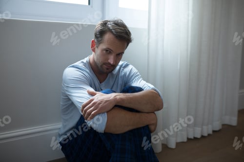 Preview: Sad man sitting at home
