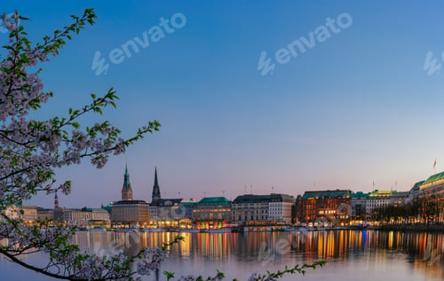 Preview: Beautiful panoramic view of calm Alster river with Hamburg town hall - Rathaus behind the buildings