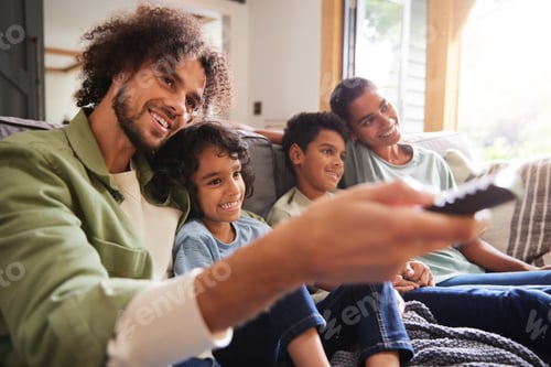 Preview: Family watching TV with father using remote