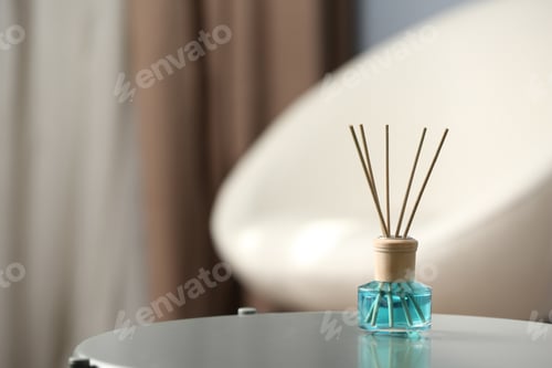 Preview: Reed air freshener on table indoors, space for text