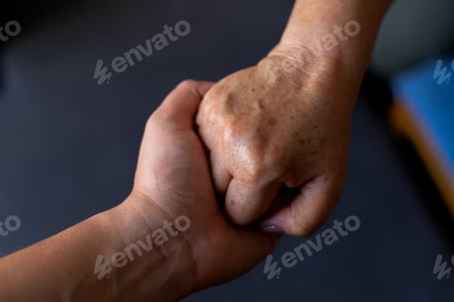 Preview: Mother and Son's Hands Clasped Together