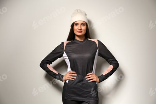 Preview: Woman wearing thermal underwear and hat on light grey background. Winter sport clothes