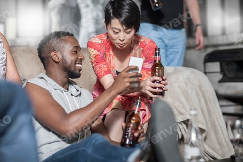 Preview: Friends together having a good time looking at cellphone