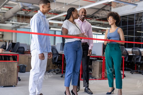 Preview: Celebrating office opening, diverse business team cutting ribbon, smiling together