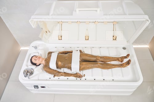 Preview: Happy woman during pleasant cellulite reduction procedure in beauty clinic
