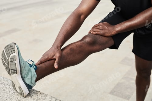 Preview: Man doing stretching exercises outdoors