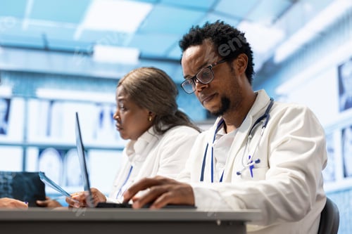 Preview: Medics in a private clinic examining test results and x ray scans