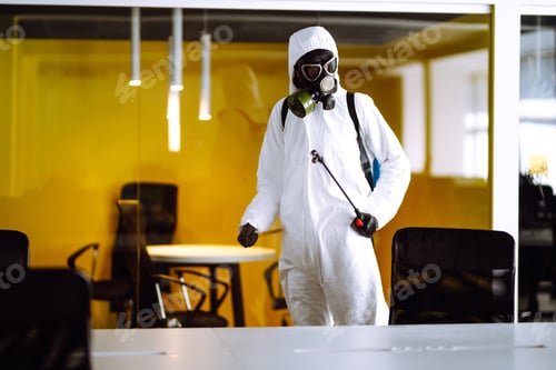 Preview: Disinfecting of office to prevent COVID-19, Man in protective hazmat suit with spray chemicals.