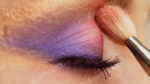 Preview: Make-up artist applies makeup to the upper eyelid, close-up. Makeup artist applies a bright shadow