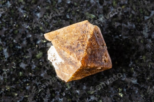 Preview: sample of rough zircon crystal on black granite