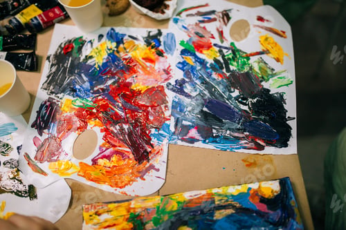 Preview: Multicolored palette in art studio, bright acrylic paints