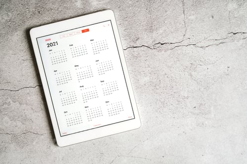 Preview: a tablet with an open calendar for 2021 year on a gray concrete background. space for text