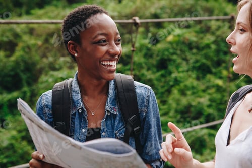 Preview: Happy woman navigating with a map