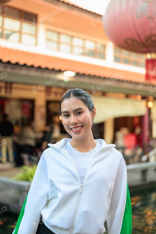 Preview: Young Asian Woman in Sporty Casual Outfit Outdoors in Zen Garden