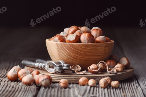 Preview: Hazelnuts and nut cracker on rustic wooden table