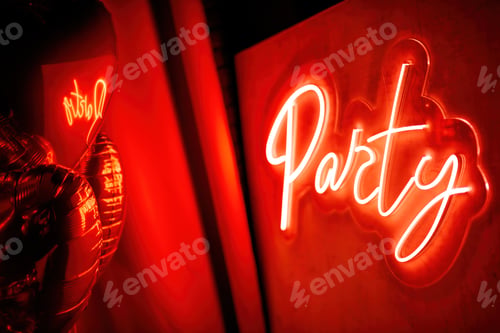 Preview: Party neon led sign board on wall by graphic font at valentines day celebration with heart balloons