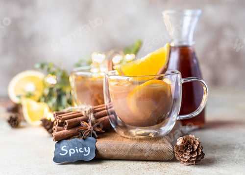 Preview: Autumn or winter hot tea or punch with orange and spices in a glass cup.