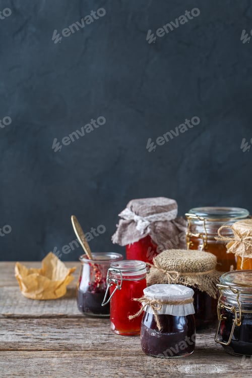 Preview: Assortment of seasonal berries and fruits jams in jars