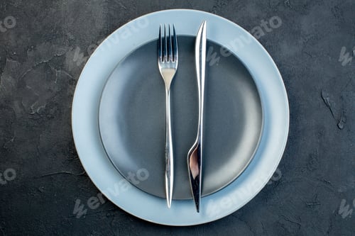 Preview: top view elegant plates with fork and knife on dark background grace hunger silverware colourful