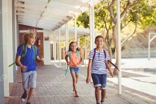 Preview: Happy school kids running in corridor