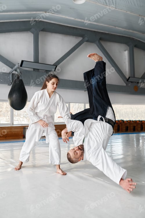 Preview: Talented female student throwing aikido teacher on floor