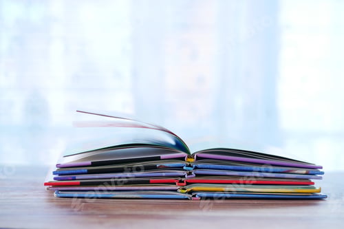 Preview: stack of colorful books on table with copy space