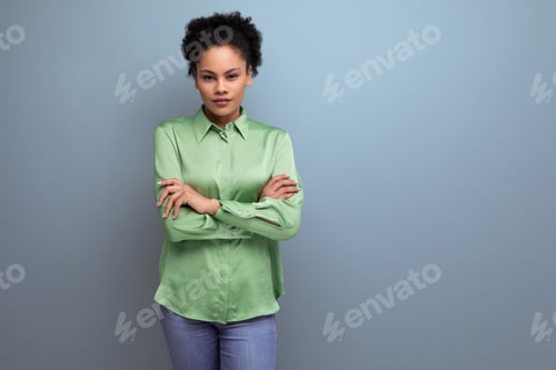 Preview: charming young brunette hispanic woman dressed in a green blouse on the background with copy space