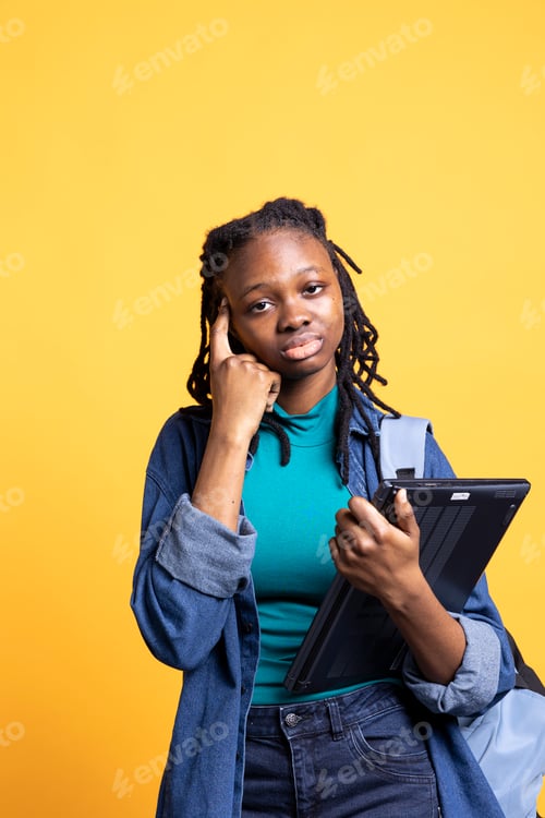 Preview: Portrait of pensive woman with laptop coming up with idea for school homework