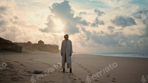 Preview: Serene woman admiring ocean beach on cloudy day. Peaceful weekend on sea shore