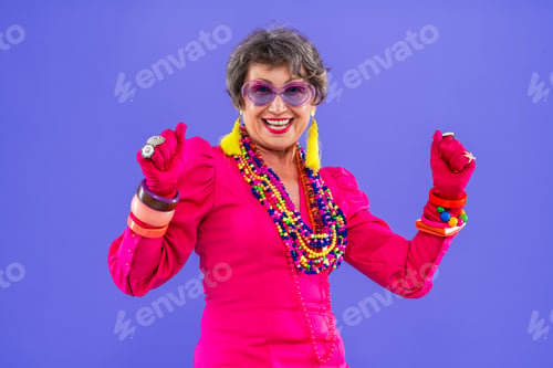 Preview: Happy and funny senior old woman on colorful background