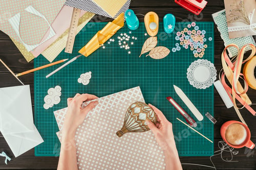 Preview: cropped image of woman putting wooden balloon on sheet of paper