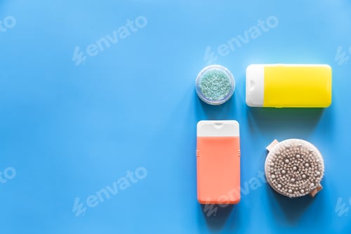 Preview: Flat lay spa composition with skin care products on blue background.
